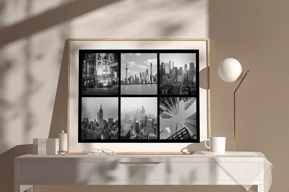 Collage de ciudades en blanco y negro con marco de madera sobre un aparador claro, regalo para recordar un viaje